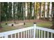 Backyard with a fire pit area viewed from the deck area with white fence at 4765 Fellswood Dr, Stone Mountain, GA 30083