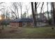 Spacious backyard features a deck area and mature trees at 4765 Fellswood Dr, Stone Mountain, GA 30083