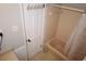 Bathroom featuring a shower/tub combo with neutral tile and a door with hooks at 4765 Fellswood Dr, Stone Mountain, GA 30083