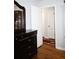 View of an open bedroom doorway with hardwood floors, and a dark wood dresser at 4765 Fellswood Dr, Stone Mountain, GA 30083