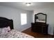 Bedroom featuring hardwood floors, a window and dark wood furnishings at 4765 Fellswood Dr, Stone Mountain, GA 30083