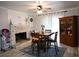 Cozy dining room features a brick fireplace, wood table with seating, and built-in cabinet at 4765 Fellswood Dr, Stone Mountain, GA 30083