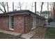 Charming brick home showcasing large windows and a concrete side patio at 4765 Fellswood Dr, Stone Mountain, GA 30083