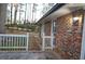 A view of the brick exterior with the white fence and a well-lit exterior at 4765 Fellswood Dr, Stone Mountain, GA 30083