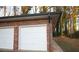 A two-car garage is built with a brick design at 4765 Fellswood Dr, Stone Mountain, GA 30083