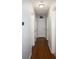 Hallway with hardwood floors, white trim, and multiple doors providing access to rooms at 4765 Fellswood Dr, Stone Mountain, GA 30083