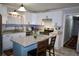 Well-lit kitchen featuring white cabinetry, granite countertops, stainless steel appliances, and a central island at 4765 Fellswood Dr, Stone Mountain, GA 30083