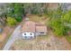 Aerial view of house, roof, yard, and driveway surrounded by trees in neighborhood at 6684 Heathrow Ln, Stone Mountain, GA 30087