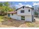 Back of house showing back door, back sliding glass door and a grey brick chimney at 6684 Heathrow Ln, Stone Mountain, GA 30087