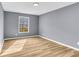 Bedroom with light wood-look flooring and a large window at 6684 Heathrow Ln, Stone Mountain, GA 30087