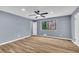 Spacious bedroom with a ceiling fan, a window, and light-colored wood-look flooring at 6684 Heathrow Ln, Stone Mountain, GA 30087