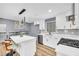 Bright, white kitchen featuring a large island with seating and stainless steel appliances at 6684 Heathrow Ln, Stone Mountain, GA 30087