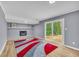 Cozy living room with a gray brick fireplace and a sliding glass door to the backyard at 6684 Heathrow Ln, Stone Mountain, GA 30087