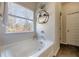 Soaking tub with window, stylish shelf and view of trees at 124 Prescott Dr, Canton, GA 30114