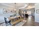 Bright dining room with hardwood floors, modern light fixture and stairway to the second floor at 124 Prescott Dr, Canton, GA 30114