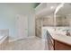 Bright bathroom featuring tile flooring, double sinks, soaking tub and walk-in shower at 2477 Misty Rose Ln, Loganville, GA 30052