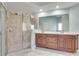 This bathroom offers double sinks, a glass enclosed shower, and tile floors at 2477 Misty Rose Ln, Loganville, GA 30052