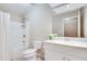 Bright bathroom features white cabinets, tiled floors, and shower-tub combo at 2477 Misty Rose Ln, Loganville, GA 30052