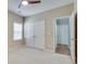 Bedroom featuring carpet, a ceiling fan, a window, and a closet at 2477 Misty Rose Ln, Loganville, GA 30052