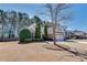 Well-kept home with beautiful landscaping and a three-car garage on a sunny day at 2477 Misty Rose Ln, Loganville, GA 30052