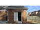 Exterior brick home with a white door and shelving visible in the backyard at 2477 Misty Rose Ln, Loganville, GA 30052