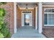 Inviting front entrance with brick columns and a classic pendant light at 2477 Misty Rose Ln, Loganville, GA 30052