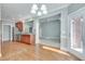 Open kitchen with stainless appliances, wood cabinets, and a seamless transition to the bright, carpeted living area at 2477 Misty Rose Ln, Loganville, GA 30052
