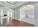 Open living room area with hardwood floors, fireplace, and decorative columns throughout at 2477 Misty Rose Ln, Loganville, GA 30052