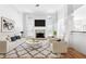 Bright living room with a fireplace, hardwood floors, and stylish decor at 2477 Misty Rose Ln, Loganville, GA 30052