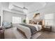 Serene main bedroom with a tray ceiling, fan, and large windows at 2477 Misty Rose Ln, Loganville, GA 30052