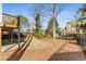 Exterior view showcasing a large backyard with mature trees and partial view of home's elevated deck at 2885 Towne Village Dr, Duluth, GA 30097
