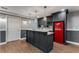 Basement bar area featuring gray cabinetry, wine rack, quartz countertops, and retro red refrigerator at 2885 Towne Village Dr, Duluth, GA 30097