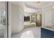 Bright bathroom featuring a soaking tub under a window and a glass-enclosed shower at 2885 Towne Village Dr, Duluth, GA 30097