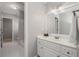 Bright bathroom featuring a white vanity with a large mirror and adjacent doorways at 2885 Towne Village Dr, Duluth, GA 30097