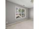 Bedroom with neutral paint, large window and light-colored carpet at 2885 Towne Village Dr, Duluth, GA 30097