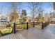 View of the backyard from the wooden deck with black metal railings at 2885 Towne Village Dr, Duluth, GA 30097