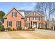 Lovely two-story brick home featuring black shutters and an inviting front lawn at 2885 Towne Village Dr, Duluth, GA 30097