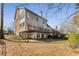 Exterior angle of home with a spacious backyard and elevated deck at 2885 Towne Village Dr, Duluth, GA 30097
