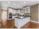 Open kitchen featuring white cabinets, hardwood flooring and a center island at 2885 Towne Village Dr, Duluth, GA 30097