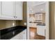 View of the kitchen area, highlighting the black granite countertops, and white cabinets at 2885 Towne Village Dr, Duluth, GA 30097