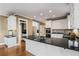 Kitchen island with black granite countertop and white cabinets, equipped with stainless steel appliances at 2885 Towne Village Dr, Duluth, GA 30097