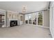 Sunlit living room with a fireplace, built-in shelving, and large windows providing natural light at 2885 Towne Village Dr, Duluth, GA 30097