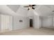 Expansive main bedroom featuring a tray ceiling, neutral walls, plush carpet, and modern ceiling fan at 2885 Towne Village Dr, Duluth, GA 30097