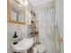 Bright bathroom featuring white tile, open shelving, and patterned shower curtain at 327 3Rd Ne St # 1, Atlanta, GA 30308