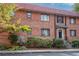 Brick townhouse with black awnings over the windows and an ornate water feature at 327 3Rd Ne St # 1, Atlanta, GA 30308