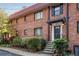 Charming brick townhouse with a red tile roof and well-manicured landscaping at 327 3Rd Ne St # 1, Atlanta, GA 30308