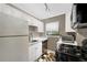 Functional kitchen featuring white cabinets, stainless steel appliances, and checkered floors at 327 3Rd Ne St # 1, Atlanta, GA 30308