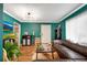 Inviting living room with hardwood floors, teal walls, and modern lighting at 327 3Rd Ne St # 1, Atlanta, GA 30308