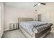 Spacious main bedroom featuring a large upholstered bed, ceiling fan, and neutral carpeting at 668 Sprayberry Dr, Stockbridge, GA 30281