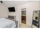 Large main bedroom featuring ensuite bath, tv and decorative mirror at 668 Sprayberry Dr, Stockbridge, GA 30281